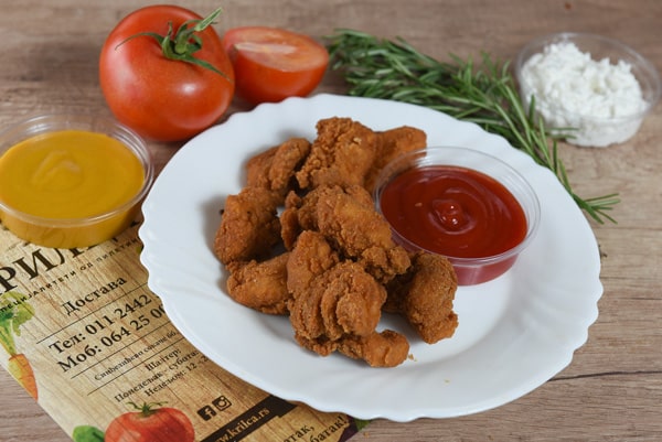Fried pieces of chicken breasts delivery