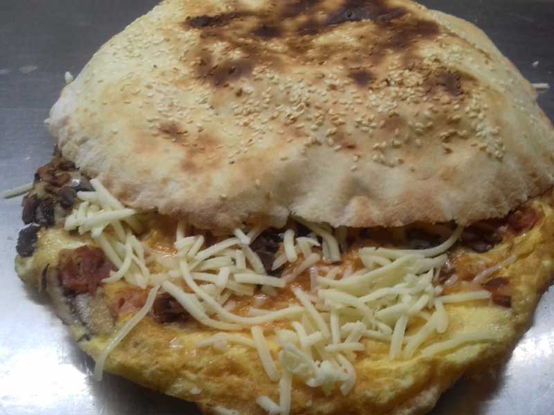 Omelet with cheese and sour cream in bun delivery