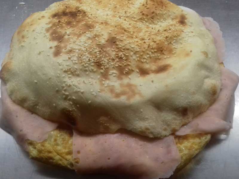 Omelet with ham, cheese and sour cream in bun delivery