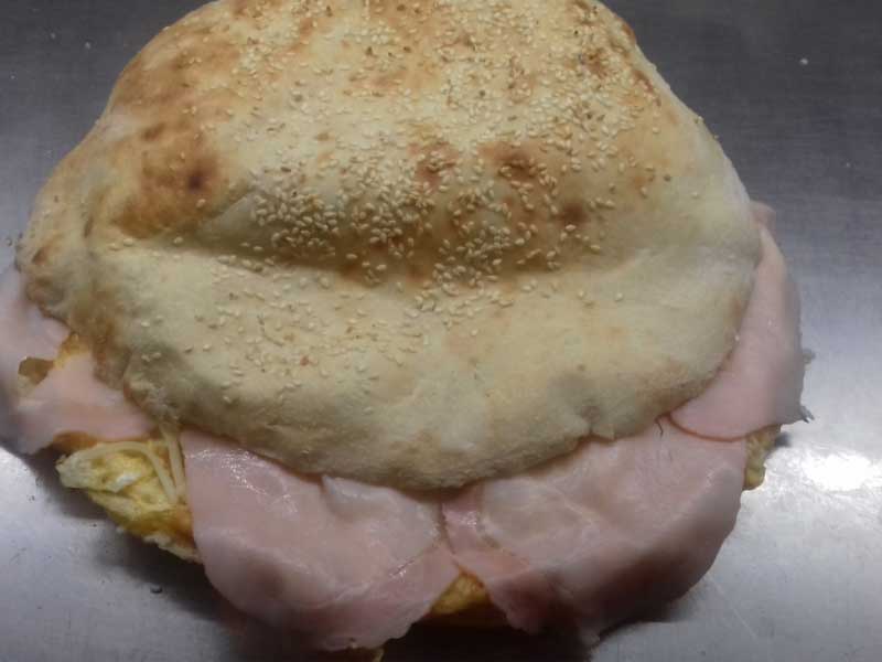 Omelet with pecenica, cheese and sour cream in bun delivery