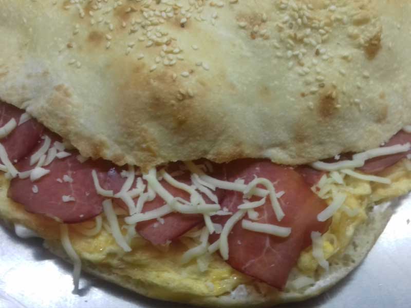 Omelet with beef prosciutto, cheese and sour cream in bun delivery
