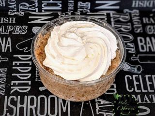 Grain with nuts and whipped cream in a glass delivery