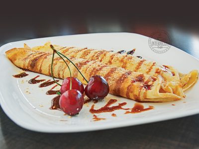 Pancakes with eurocream, plazma biscuit and cherry Cyrano Caffe Pizzeria delivery