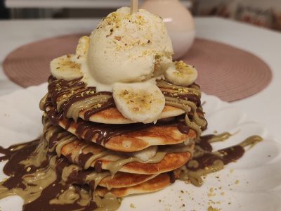 Pancake with nutella, pistachio cream, banana, vanilla ice cream, pistachio Caffe Waffle delivery