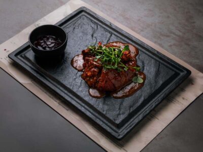 Slow-cooked pork ribs baked in mibrasa Balkan Distrikt delivery