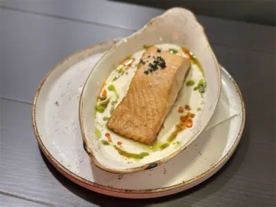 Salmon in bechamel sauce with chive and pepper emulsion Balkan Distrikt delivery