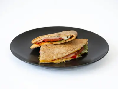 Folded tortilla with eggs and prosciutto protein Protein Bite delivery